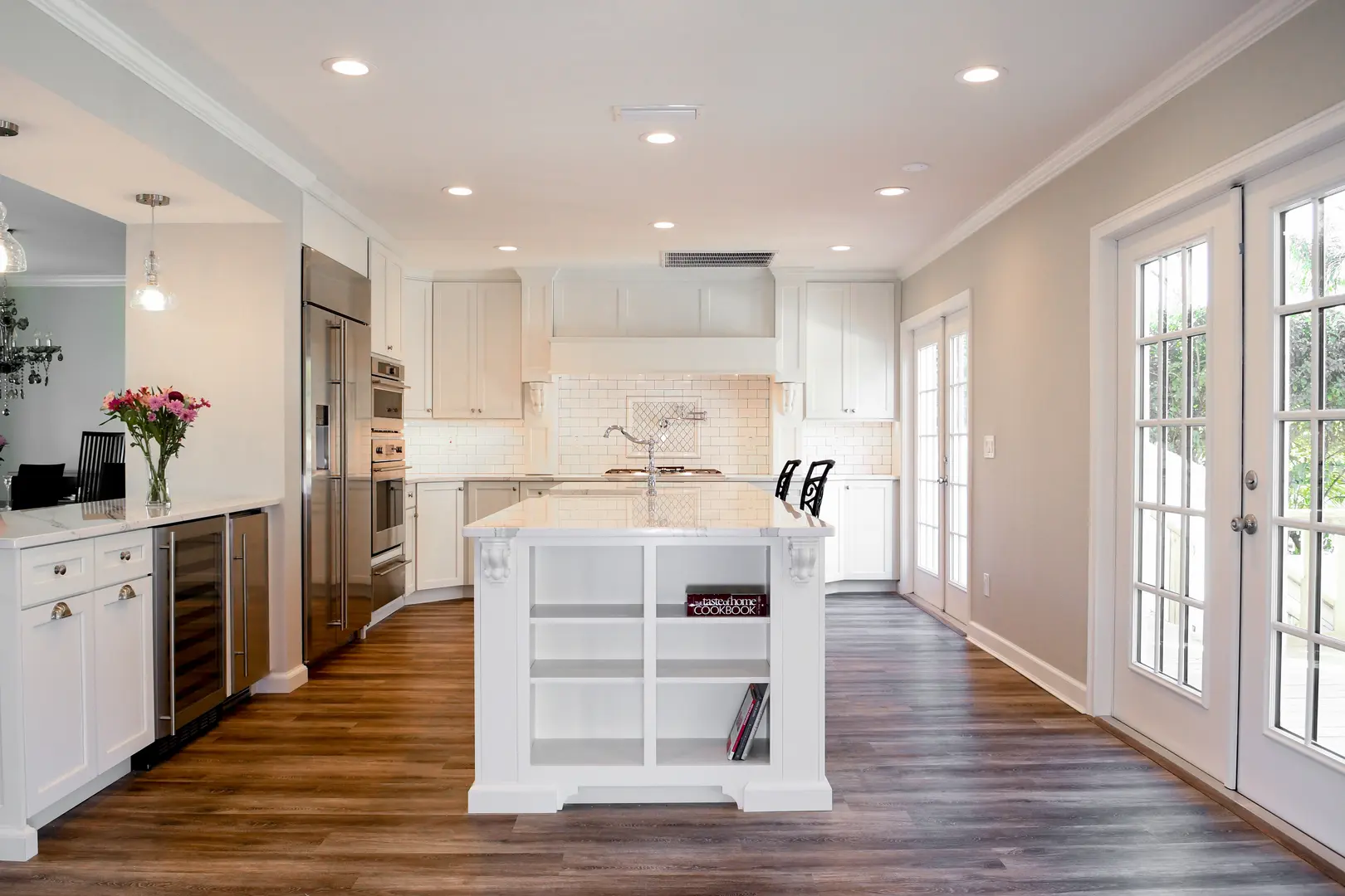 Modern kitchen with island and wooden floor.