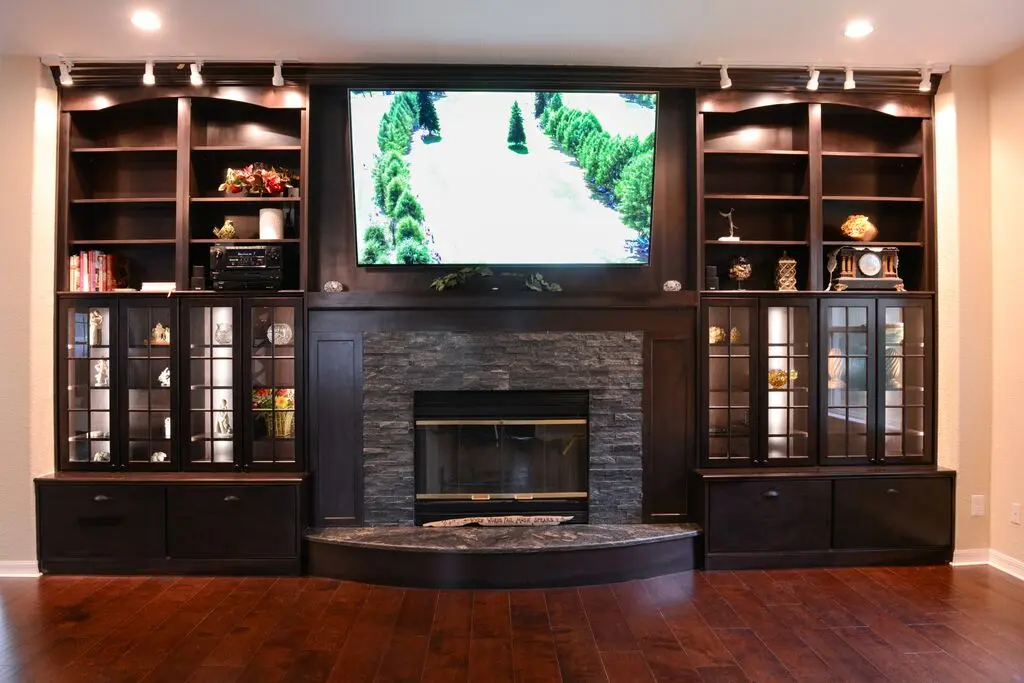 Living room with fireplace and TV unit.